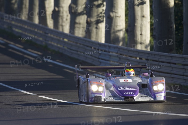 FRANCE, Le Mans, "Number 8 purple and silver Audi R8 race car with advertising and logos, exiting Tetre Rouge."