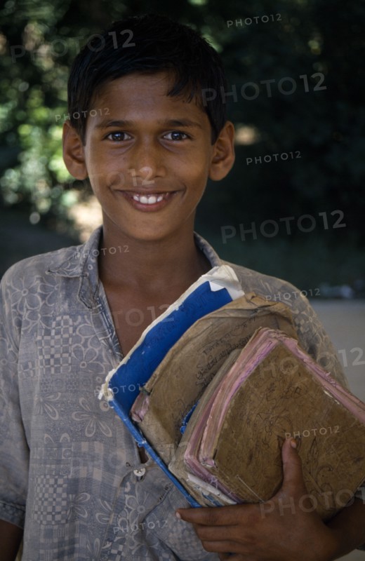BANGLADESH, Education, Portrait of boy holding school books.