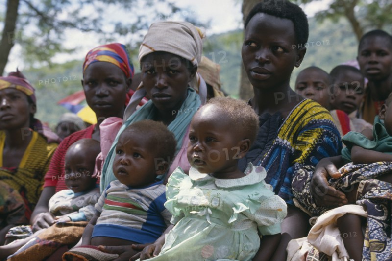UGANDA, Orukinga Refugee Camp, Women listening to nutrition advice given to mothers with vulnerable babies at food distribution in refugee camp on the Rwandan border.