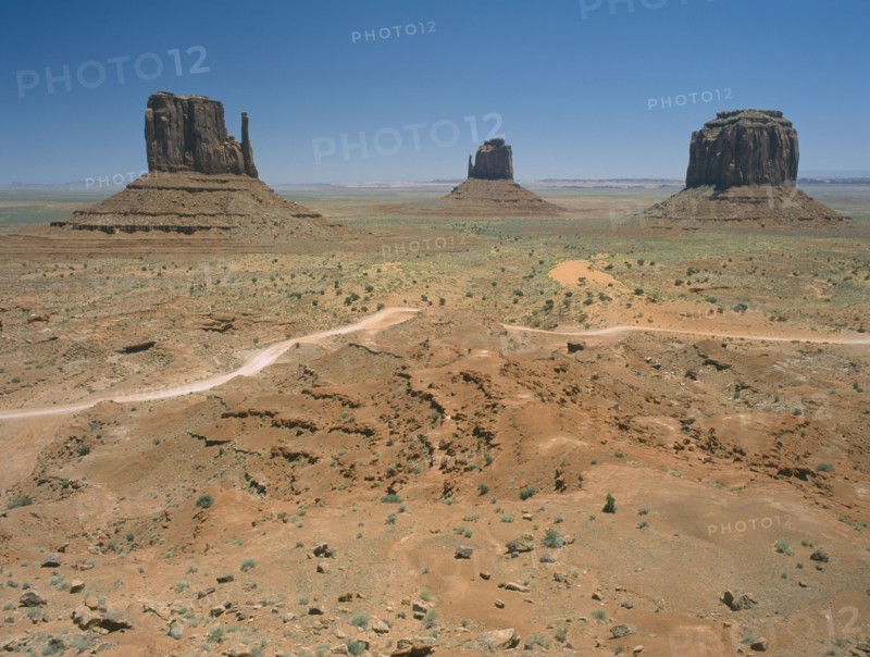 USA, Arizona, Monument Valley, Rock formations surrounded by desert and dirt roads