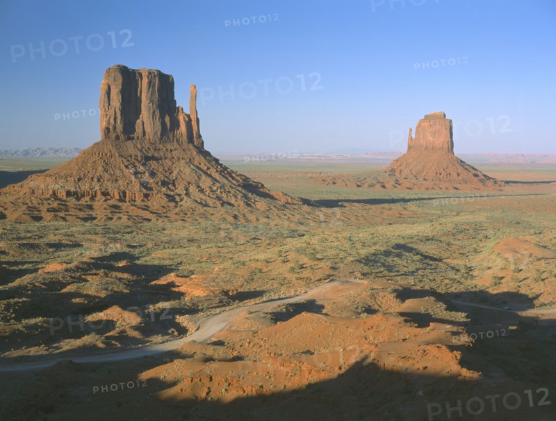 USA, Arizona, Monument Valley, Rock formations surrounded by desert in evening light