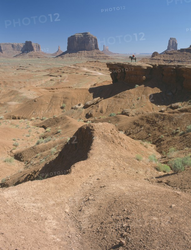 USA, Arizona, Monument Valley, A figure on horseback in the distance on John Ford Point