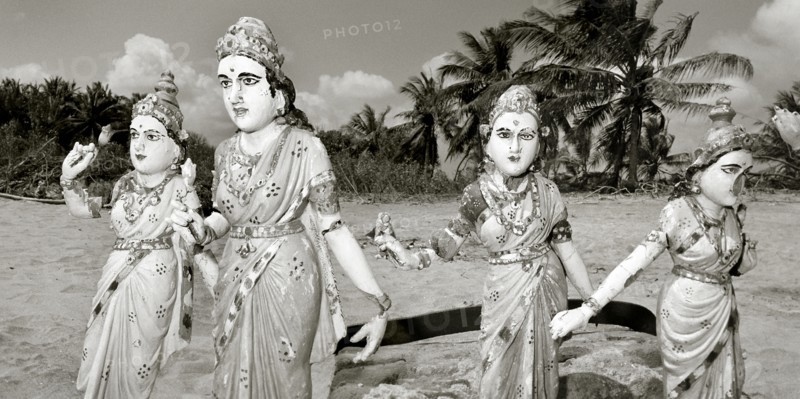 INDIA, Tamil Nadu, north of Auroville, Statues torn away from a nearby Hindu temple by the Indian Ocean Tsunami are relocated onto the beach by local villagers in order to ward off further destruction.