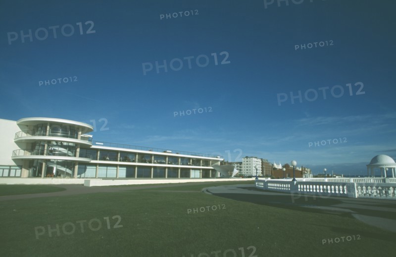 ENGLAND, East Sussex, Bexhill on Sea, De La Warr Pavilion. Exterior view from seafront over grass towards back entrance with staircase section and terracing.