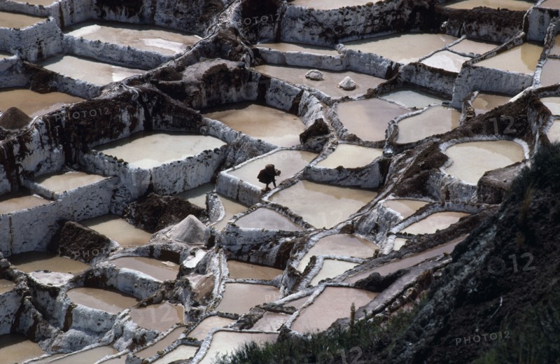 PERU, Cuzco, Salinas, Female worker on salt terraces.