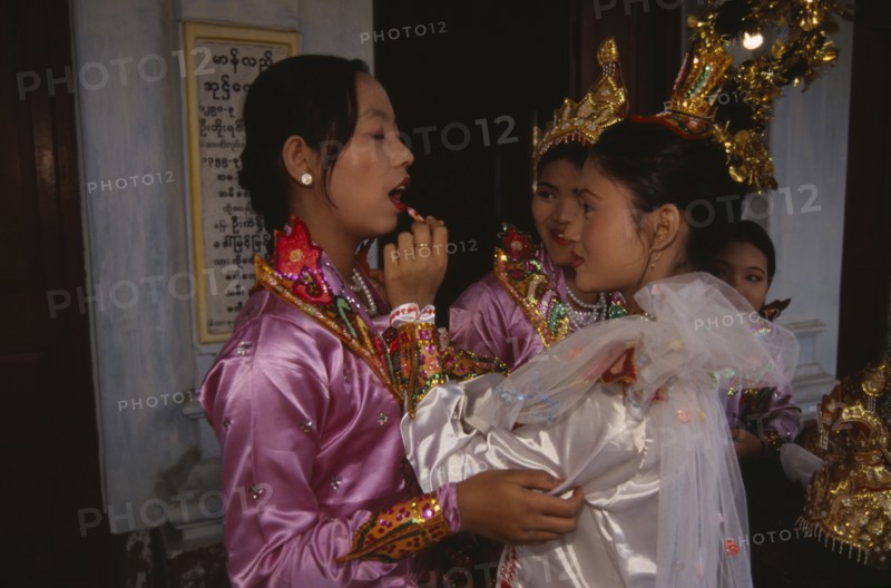 MYANMAR, Mandalay, Funeral dancers putting on make up at the funeral for an Abbot at the Endawya Paya Monastery.