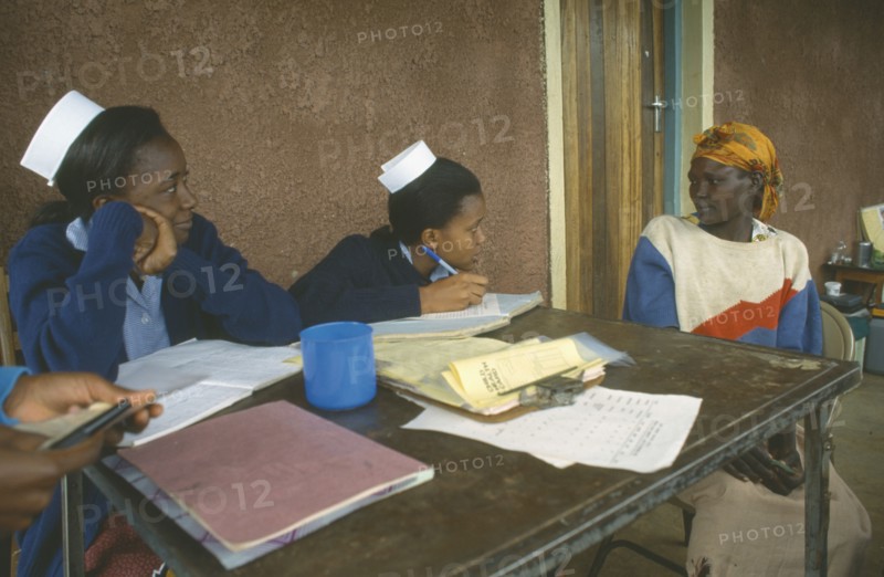 KENYA, Ortum, Nurses taking patient’s notes at Ortum hospital mobile clinic.