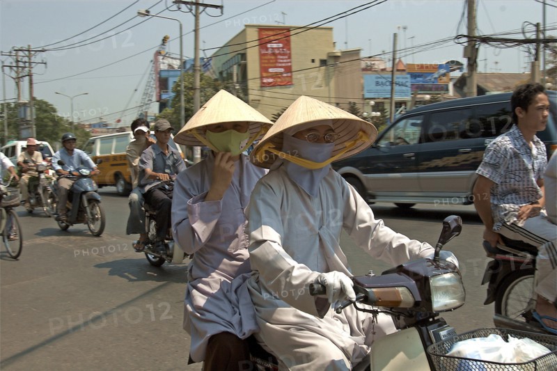 VIETNAM, South, Ho Chi Minh City, Monks in conical hats riding a a motorbike