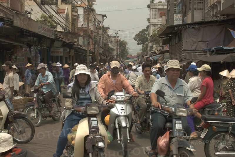 VIETNAM, South, Ho Chi Minh City, Busy traffic in downtown area with people riding motorbikes