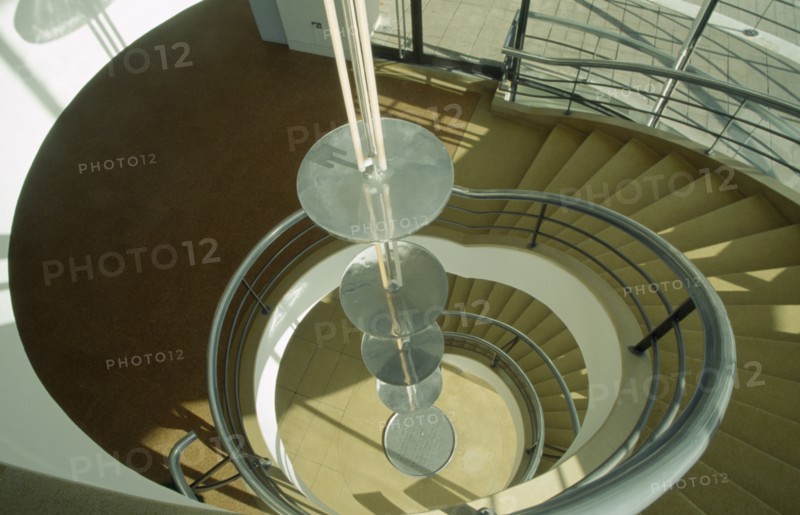 ENGLAND, East Sussex, Bexhill on Sea, De La Warr Pavilion. Interior view looking down the helix like spiral staircase and Bauhaus globe lamps.