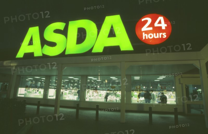 SHOPPING, Supermarkets, Asda twenty four hour supermarket. Large sign illuminated at night.