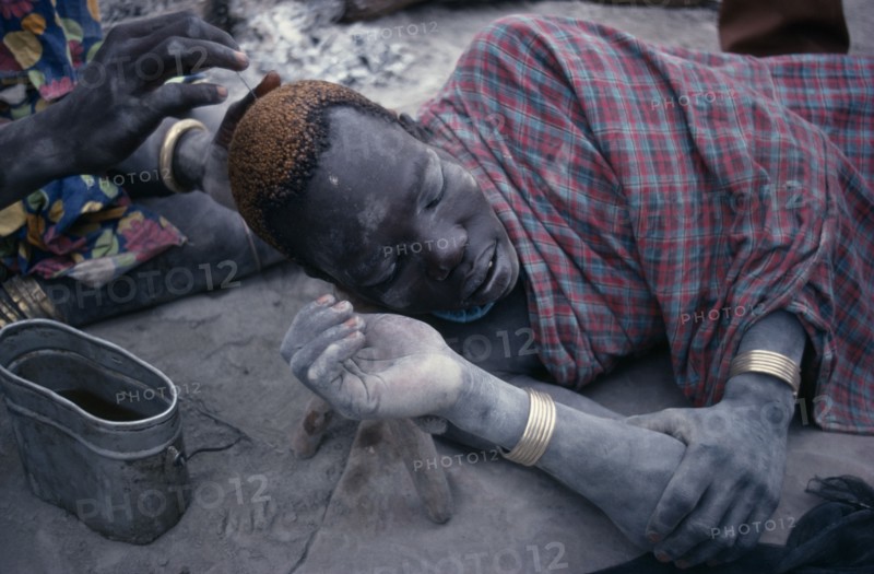 SUDAN, People, Men, Dinka man having his hair dyed using cattle urine.