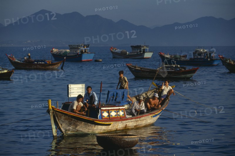 VIETNAM, Nha Trang, Fishing boats at first light off the Southern end of the beach.