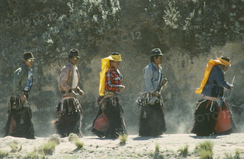ECUADOR, Pichincha, Cangahua, Men in costume for the Fiesta de San Juan in northern region near Mount Cayambe.
