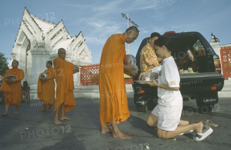 THAILAND, Bangkok, Monks collecting Alms outside Marble Temple. Wat Benchamabophit