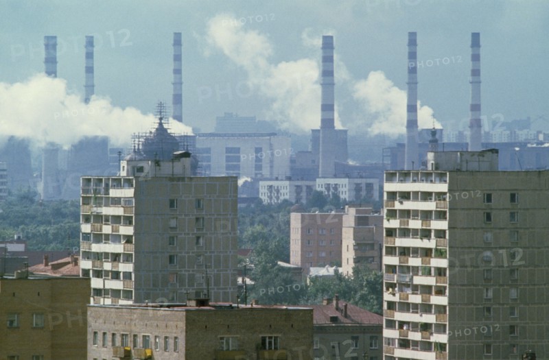 RUSSIA, Moscow, Smoke billowing from power station chimneys behind residential housing.