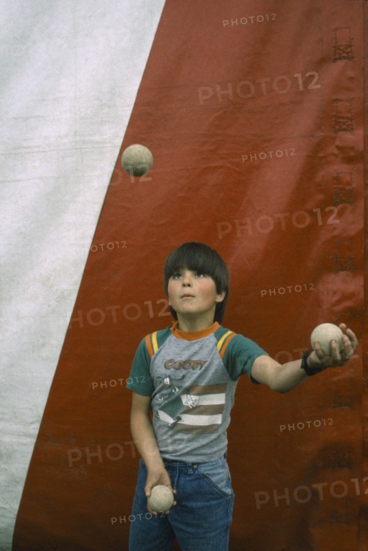 CHILDREN, Playing, Child juggling three balls.