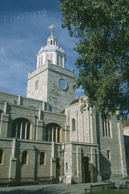 ENGLAND, Hampshire, Portsmouth, Old Portsmouth. High Street. The Cathedral of St Thomas  framed by tree branches.