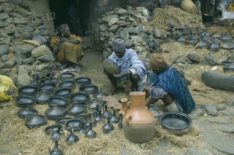 ETHIOPIA, Gondar, Black pottery for sale at market.
