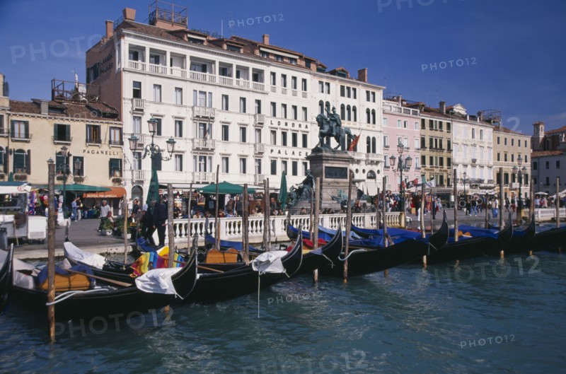 ITALY, Veneto, Venice, Gondolas moored against the Riva degli Schiavoni with the Londra Palace Hotel behind.