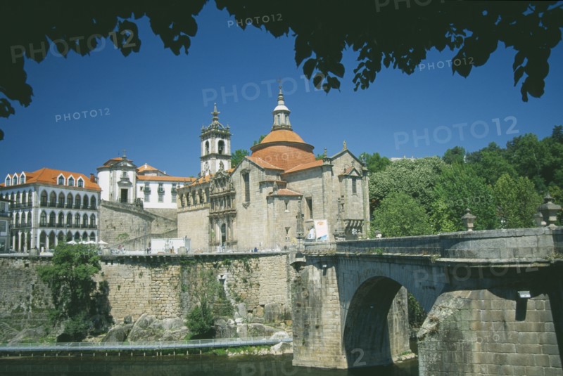 PORTUGAL, Porto, Amarante, Church of  Sao Goncalo.  Exterior view with the Ponte de Sao Goncalo across the River Tamega in the foreground part framed by trees.