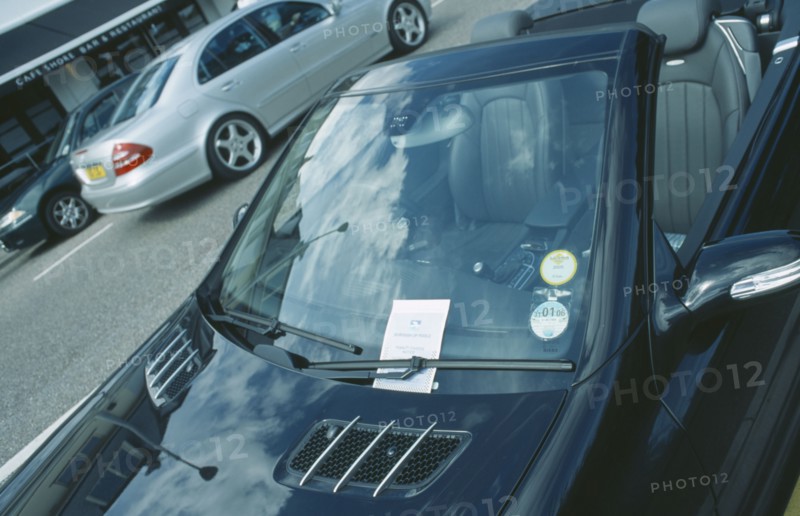 TRANSPORT, Road, Cars, Black Mercedes parked with a penality fine ticket under windscreen wiper.