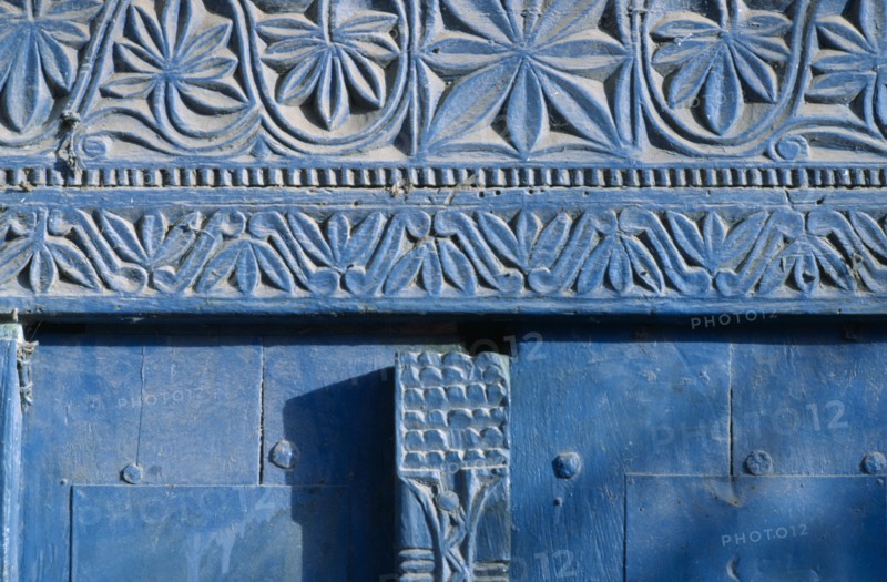 SOMALIA, Mogadishu, Detail of blue painted doorway with carved plant motif.