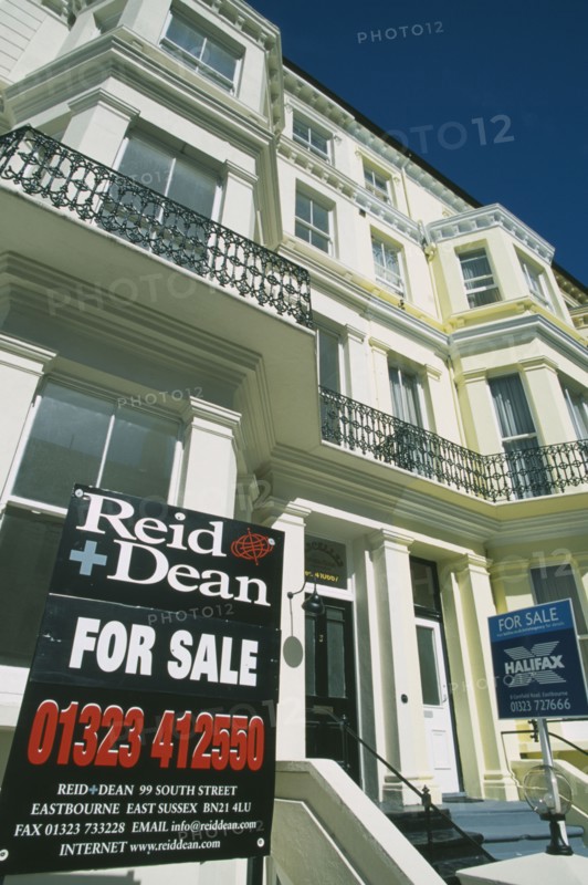 ENGLAND, East Sussex, Eastbourne, Real Estate For Sale signs outside Regency style properties.