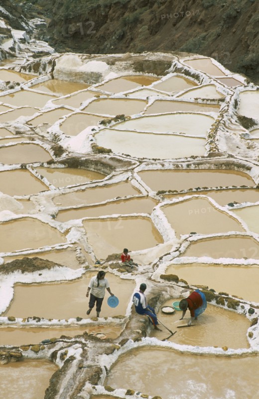 PERU, Cusco, Salineras, People working on the Salt Mines dating back to Inca times. Near Urubamba.