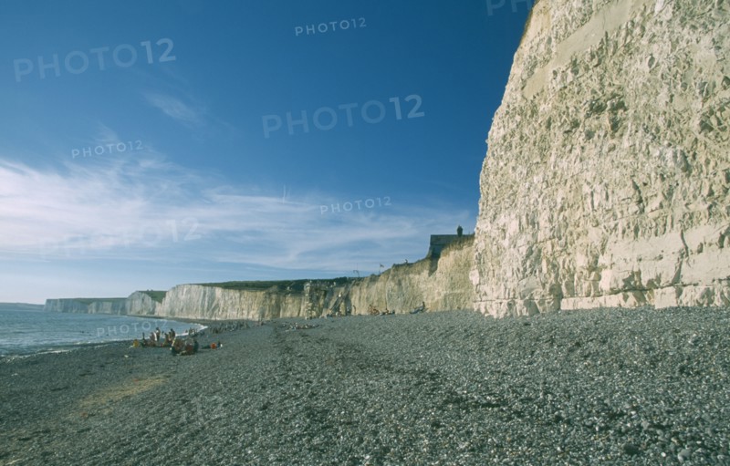 ENGLAND, East Sussex, Birling Gap, Occupied peeble beach and long section of cliff face.