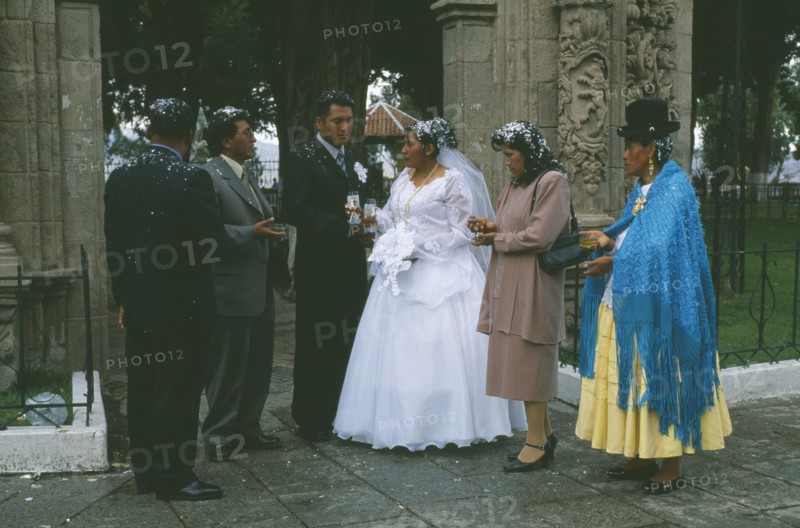 BOLIVIA, La Paz, "Wedding in El Monticulo. Bride, Groom and guests standing under archway"