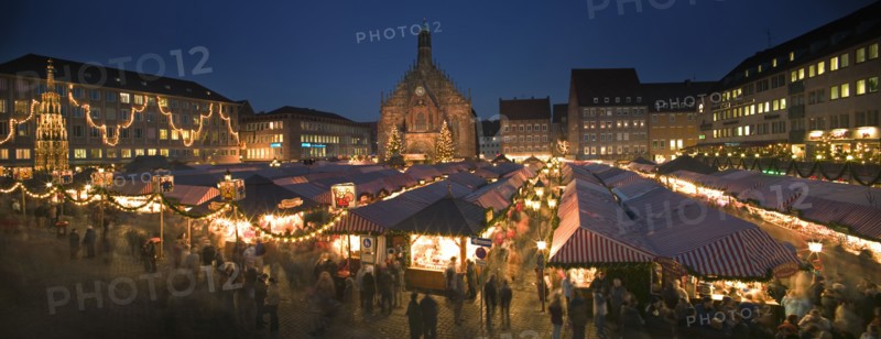 GERMANY, Bavaria, Nuremberg, Panoramic view of the Christmas Market in Hauptmarkt with The Frauenkirche behind.