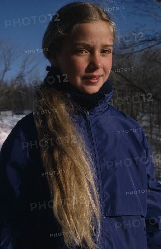 CHILDREN, Portraits, "Portrait of young girl with long blonde hair outdoors, dressed for cold weather."