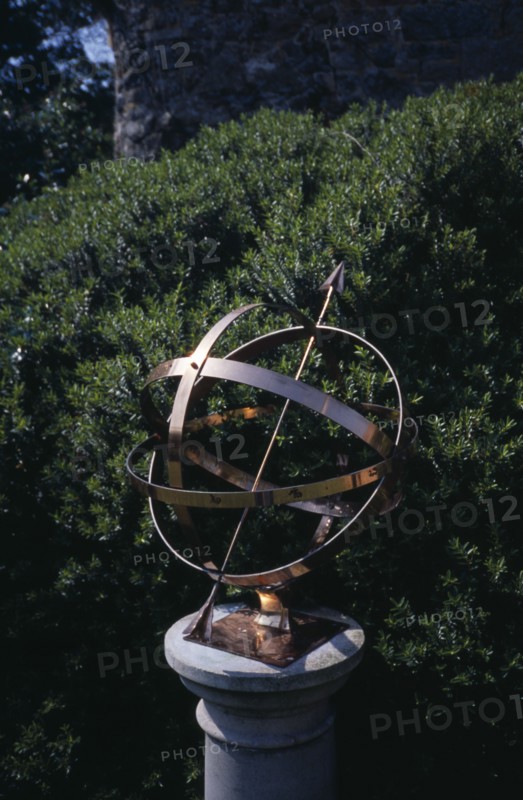 UNITED KINGDOM, Channel Islands, Guernsey, St Martins. Sausmarez Manor. Gold Sundial on plinth in garden.