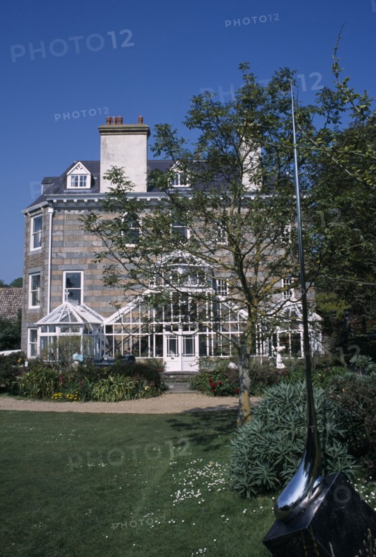 UNITED KINGDOM, Channel Islands, Guernsey, St Martins. Sausmarez Manor. View from sculpture garden towards side of house.
