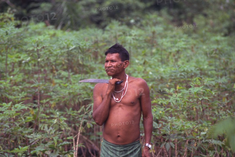 COLOMBIA, Vaupes , "Tukano indian shaman, with machete and chewing coca."
