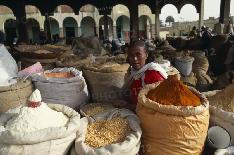 ERITREA, Asmara , "Woman selling spices, beans and lentils at market."