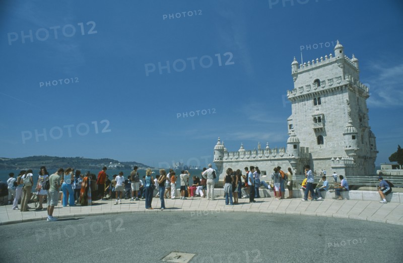 PORTUGAL, Lisbon, "Tower of Belem, tourists gathered round the fortress in the River Tagus."