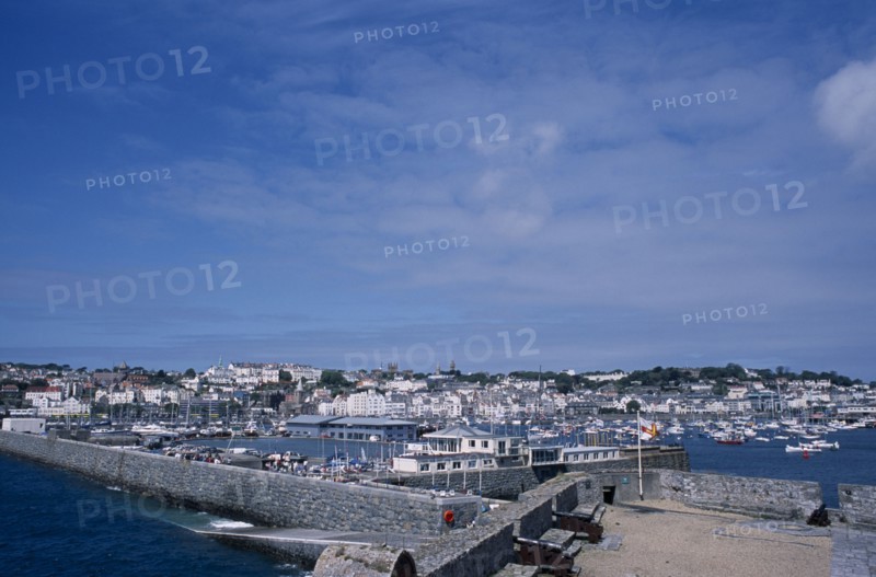 UNITED KINGDOM, Channel Islands, Guernsey, St Peter Port. Castle Cornet. View across castle walls towards marina and quayside buildings.