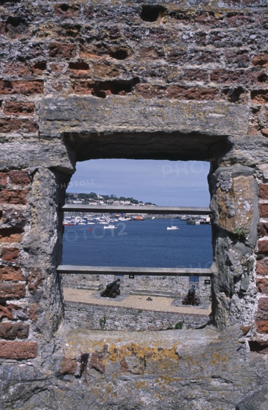 UNITED KINGDOM, Channel Islands, Guernsey, St Peter Port. Castle Cornet. View through battlement window towards St Sampson.