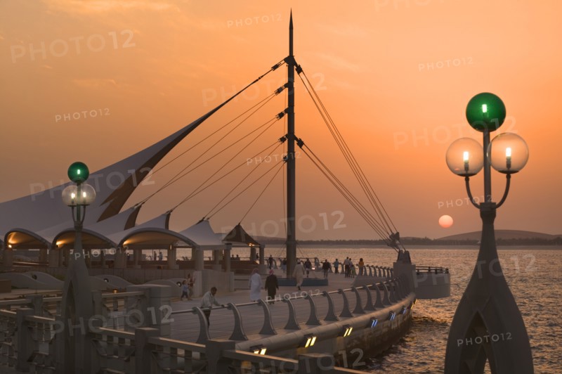 UAE, Abu Dhabi, Sun set on the Corniche promenade.