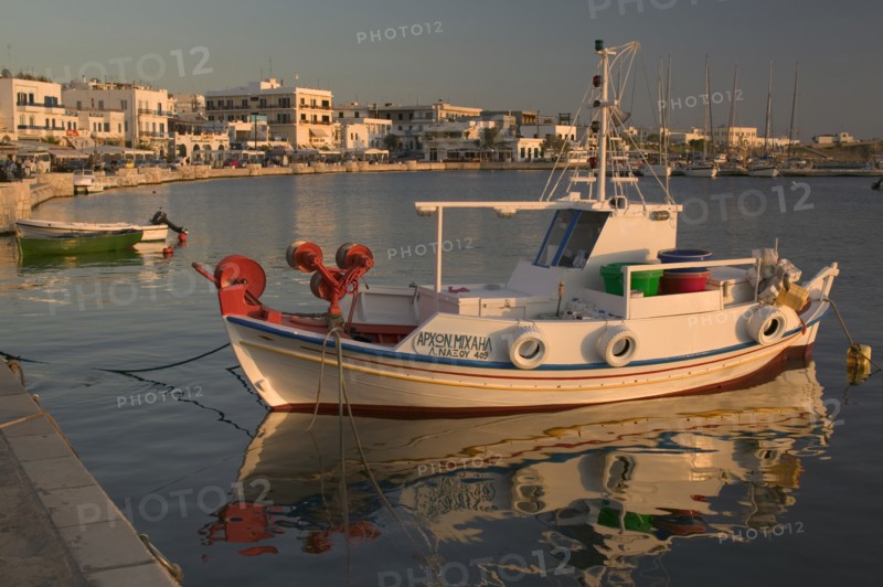 GREECE, Cyclades Islands, Naxos, HoraView of a boat docked in the port with buildings behind.