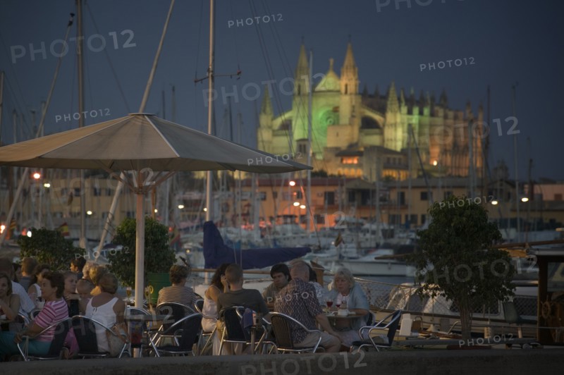 SPAIN, Balearic Islands, Mallorca, "Palma de Mallorca, Cafe with the Cathedral behind, set in the evening."