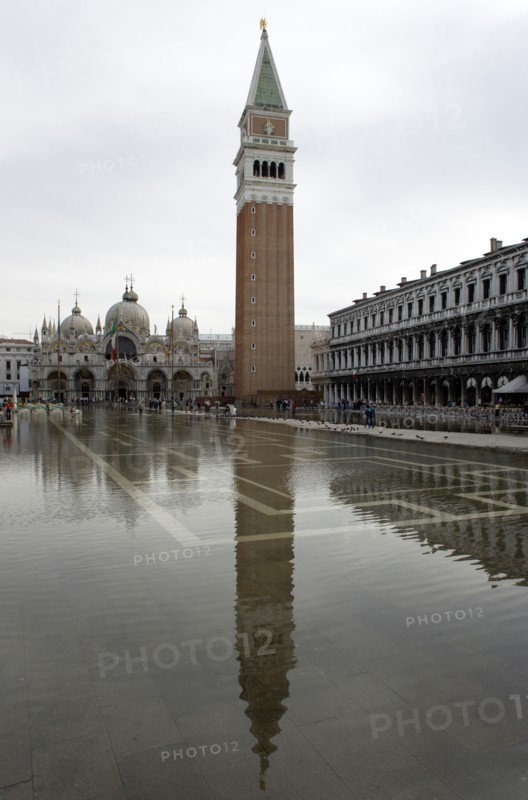 ITALY, Veneto, Venice, Aqua Alta High Water flooding in St Marks Square with St marks Basilica and the Campanile reflected in the flooded piazza