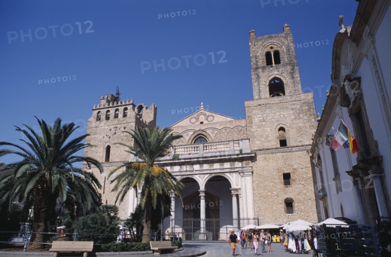 ITALY, Sicily, Palermo, Monreale. II Duomo Norman Cathedral exterior with people walking on road near small market stalls
