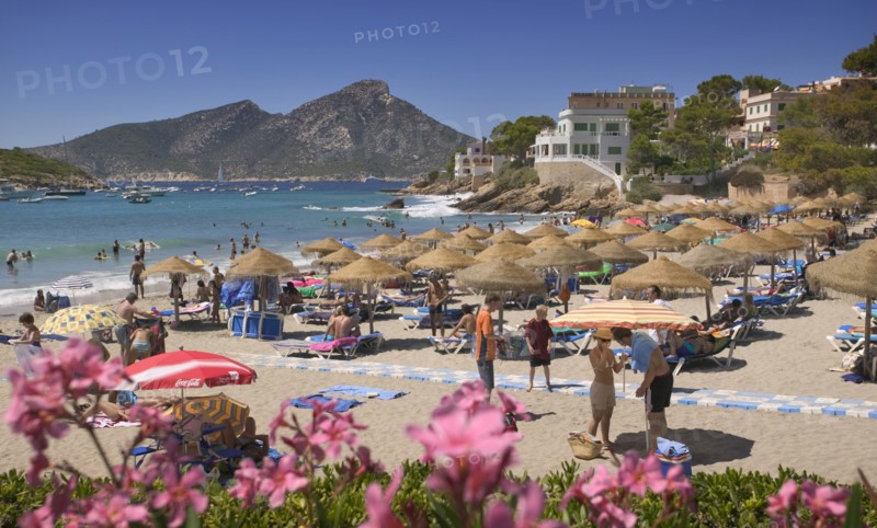SPAIN, Balearic Islands, Mallorca, "Port d'Andratx, View of the beach with sunbathers and the mountain in the background."