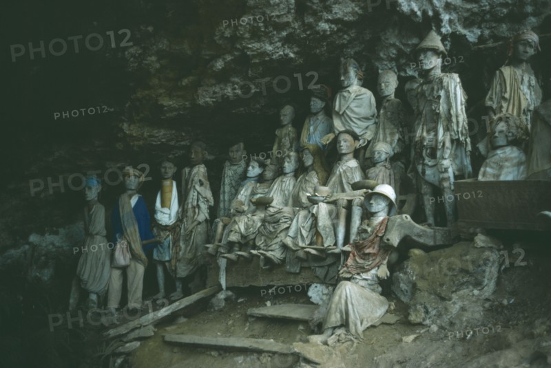 INDONESIA, Sulawesi, Toraja wooden funeral effigies or Tau Tau set into cliff cemeteries to represent the spirit of the deceased.