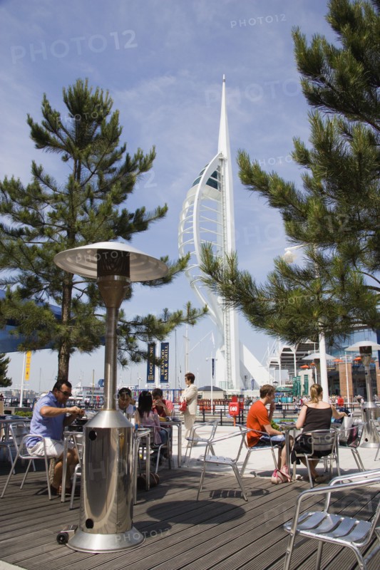 ENGLAND, Hampshire, Portsmouth, The Spinnaker Tower the tallest public viewing platforn in the UK at 170 metres on Gunwharf Quay with outdoor restaurant seating in the foreground