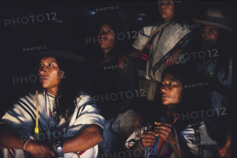 COLOMBIA, Santa Marta, Sierra Nevada , Ica family sat down and listening to Ica elder talking at night time.