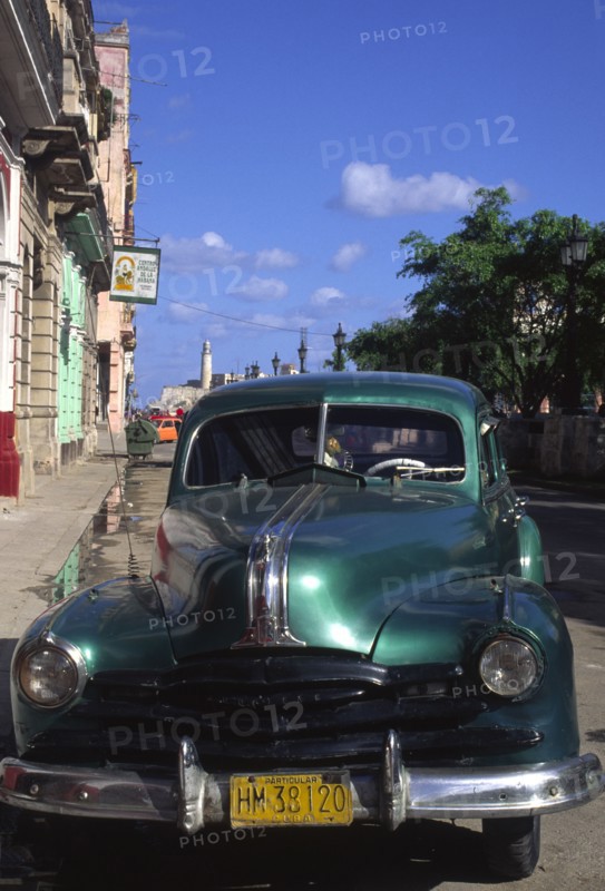 CUBA, Havana, "A classic green US 1950s car, parked on the Malecon."
